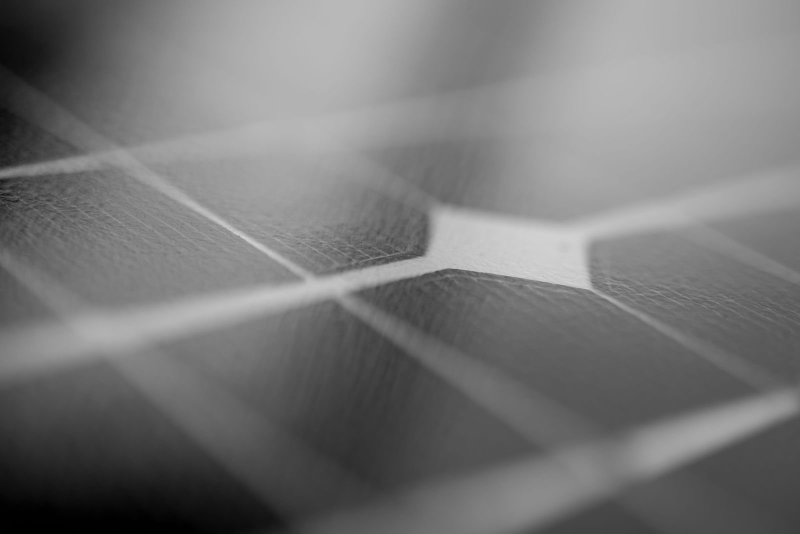 Close-up of a solar panel surface in soft grey light.